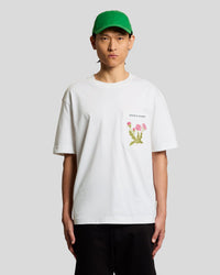 Man wears Botanical Embroidered Pocket T-Shirt in White