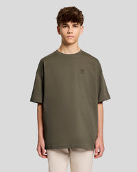 Man wears Heavy Weight Relaxed T-Shirt in Khaki Ash