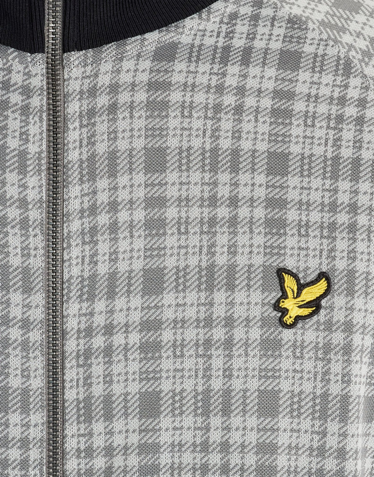 Man wears Hawick Cotton Check Track Jacket in Mid Grey Marl