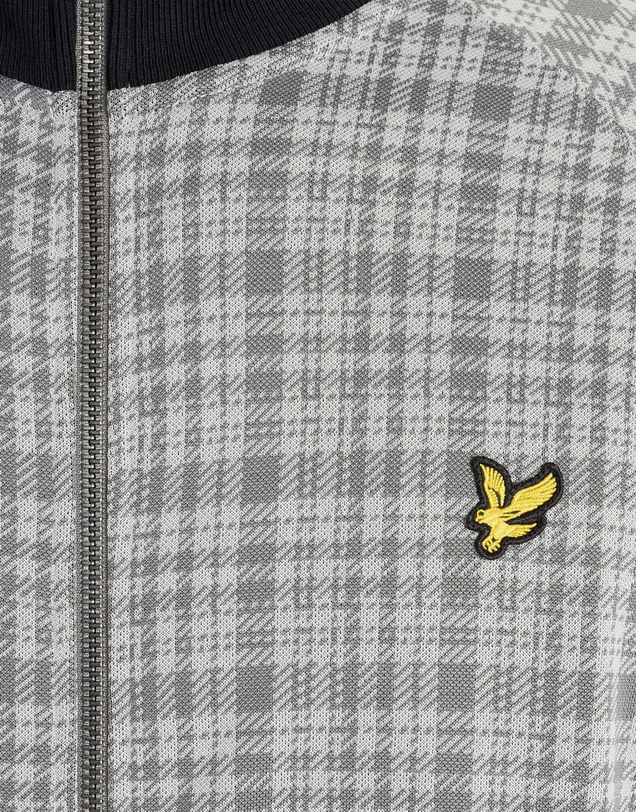 Man wears Hawick Cotton Check Track Jacket in Mid Grey Marl