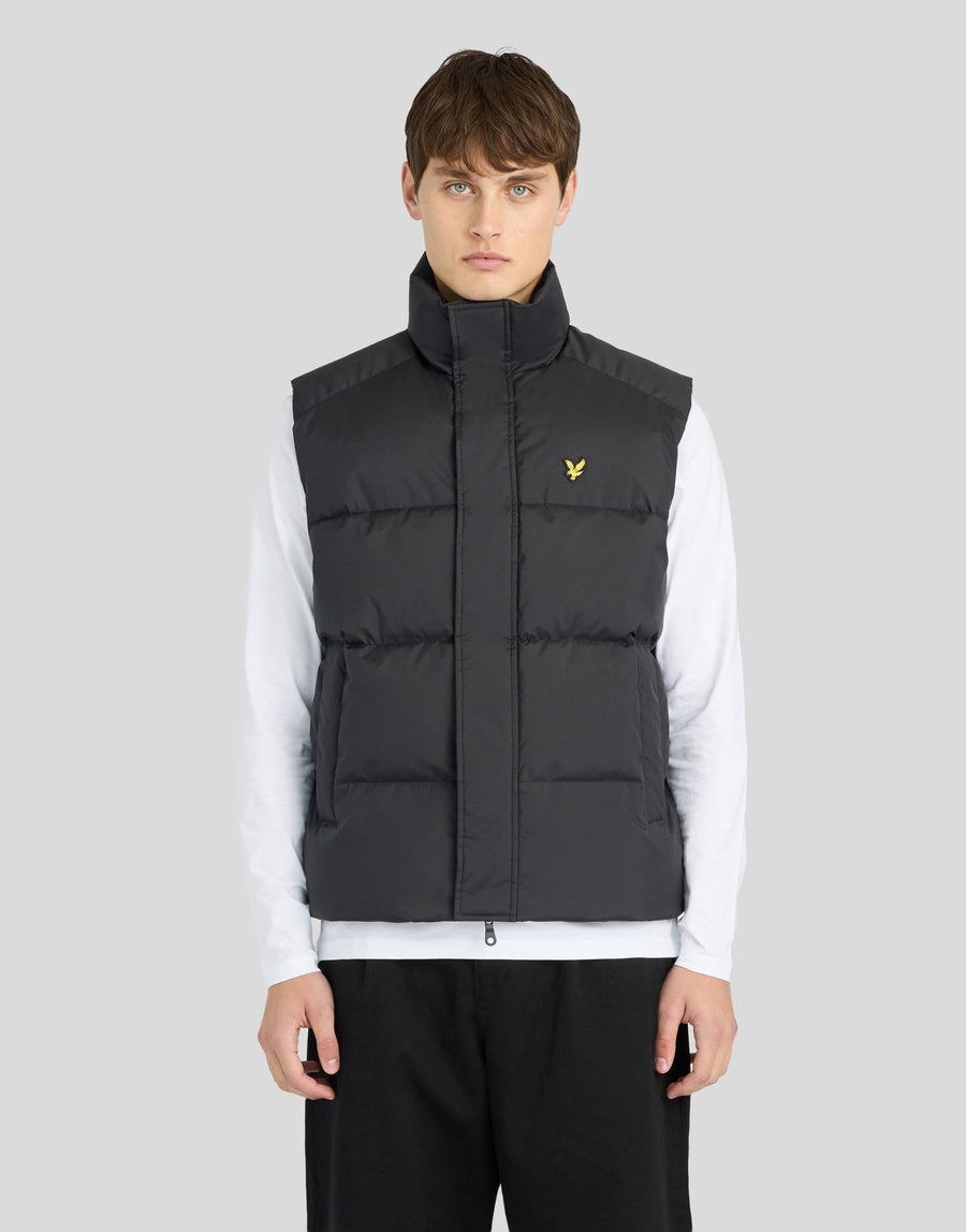 Man wears Funnel Neck Puffer Gilet in Jet Black