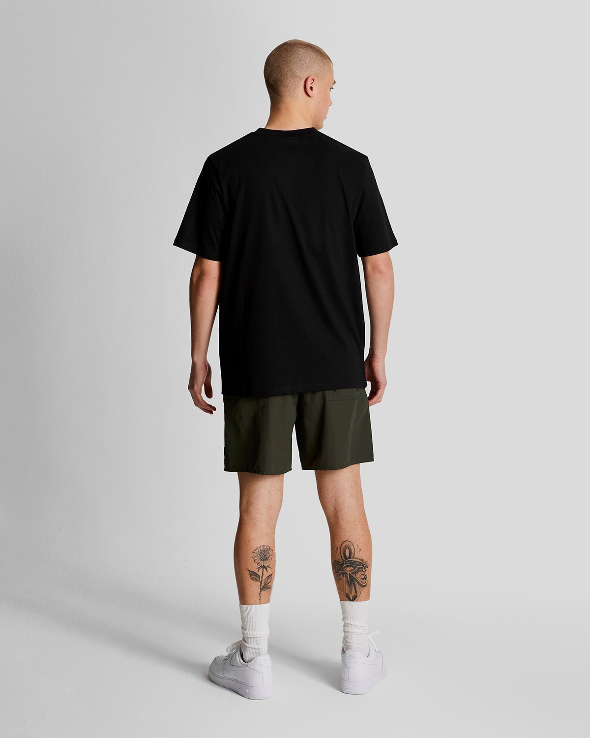 Man wears Plain Swim Shorts in Olive