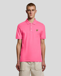 Man wears Cotton Polo Shirt in Hot Pink