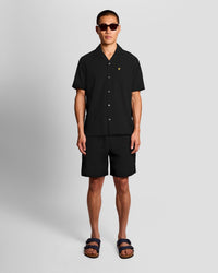 Man wears Textured Resort Shorts in Jet Black