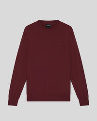 Man wears Merino Wool Crew Neck Jumper in Fairway Burgundy
