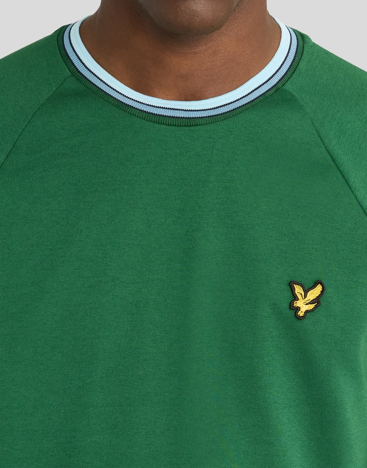 Man wears Tipped Track T-Shirt in Clover Green