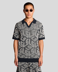 Man wears Emblem Ribbed Knitted Polo Shirt in Dark Navy/ Cove