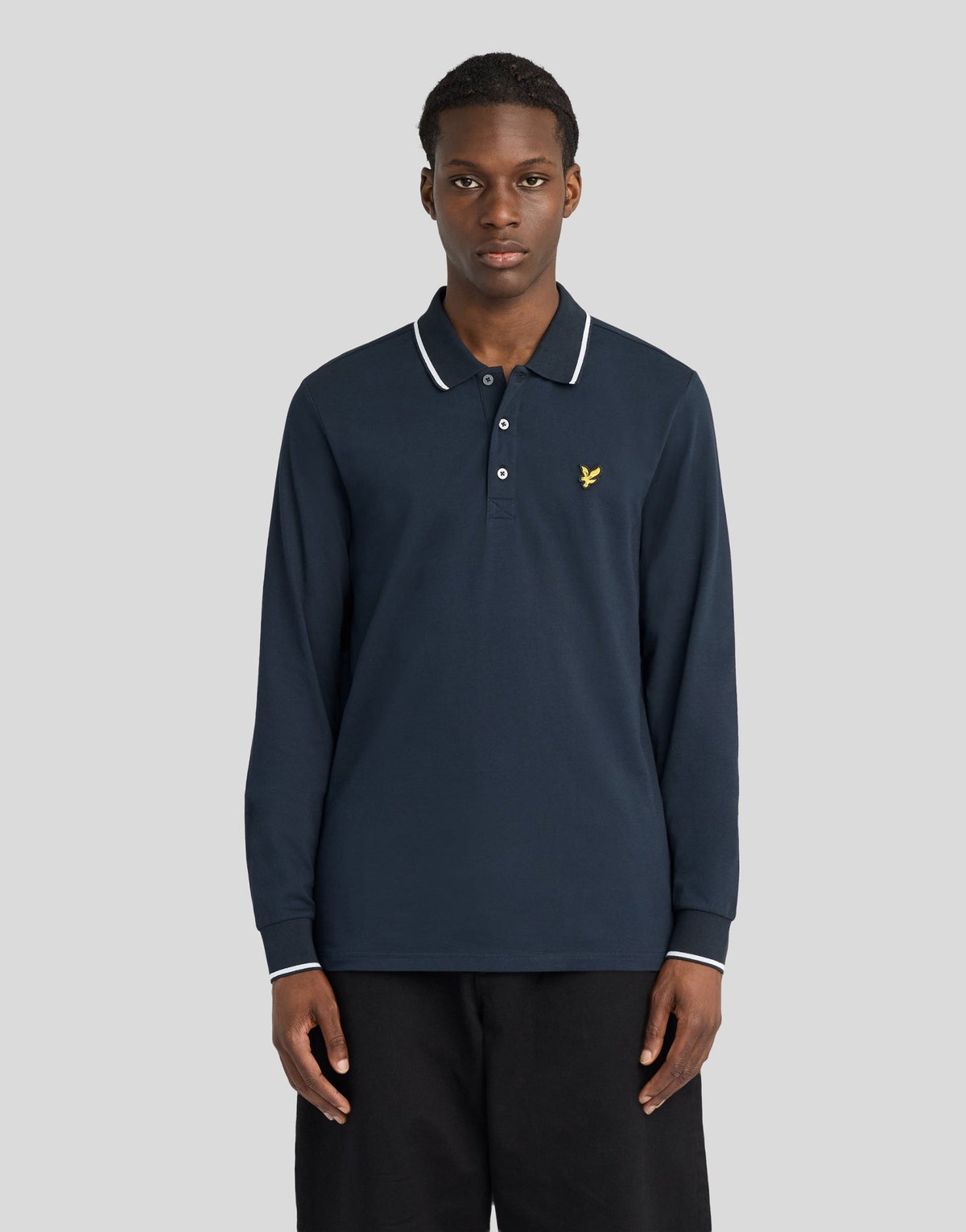 Man wears Tipped Long Sleeve Polo Shirt in Dark Navy/ White