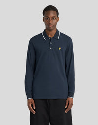 Man wears Tipped Long Sleeve Polo Shirt in Dark Navy/ White