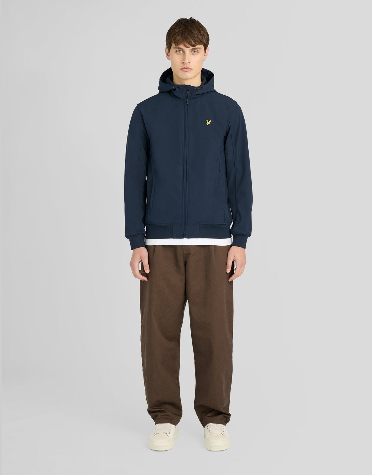 Man wears Sports Mesh-Back Softshell Jacket in Dark Navy