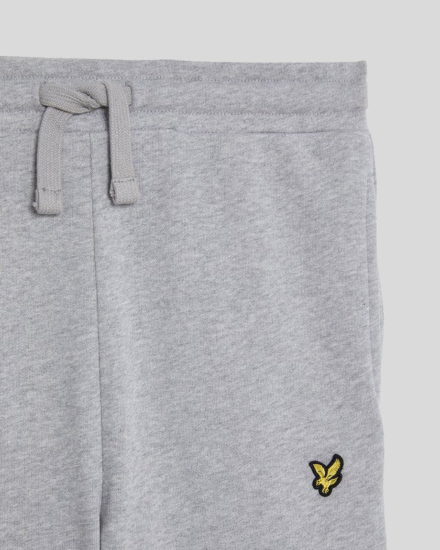 Ragazzo con pantaloni da jogging in cotone grigio chiaro melange