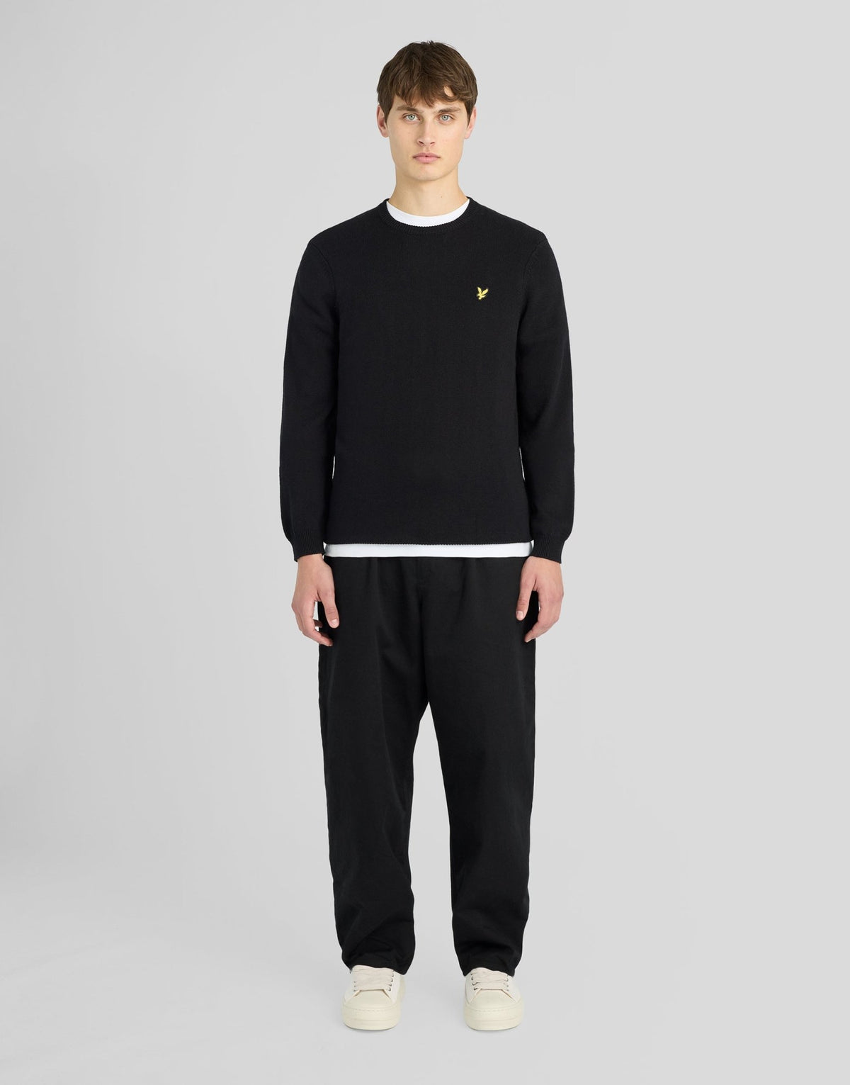 Man wears Cotton Merino Crew Neck Jumper in Jet Black