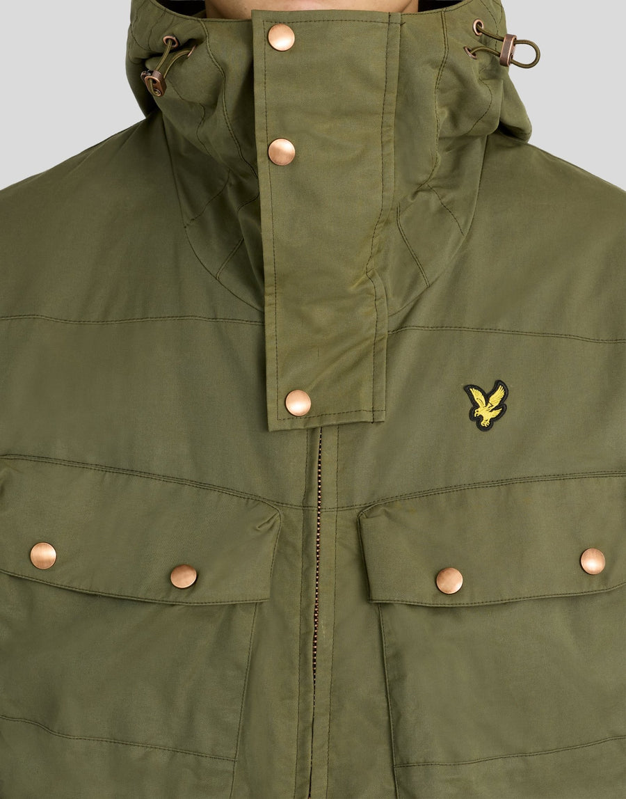 Man wears Waxed Guard Parka in True Olive