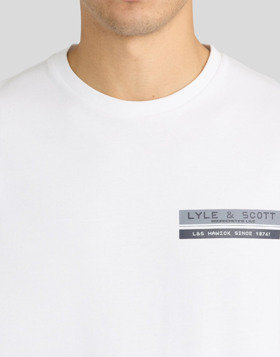Man wears TV Pixel Back Graphic T-Shirt in White