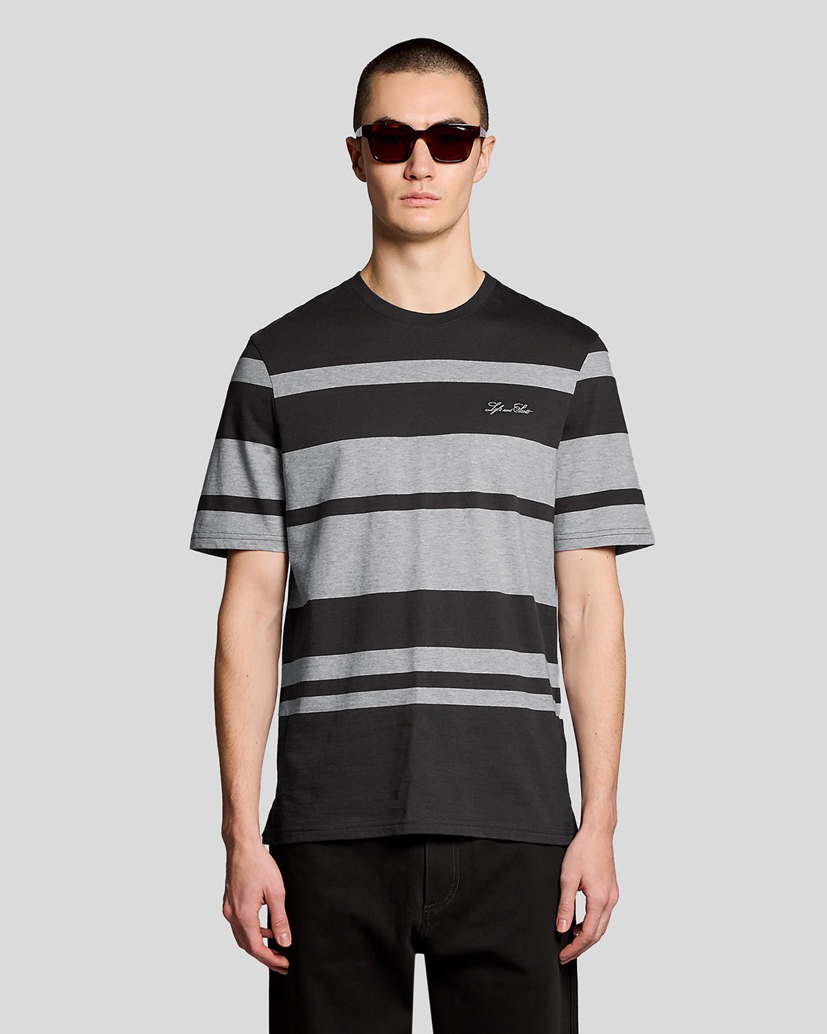 Man wears Relaxed Fit Stripe T-Shirt in Charcoal Grey/ Light Grey Marl