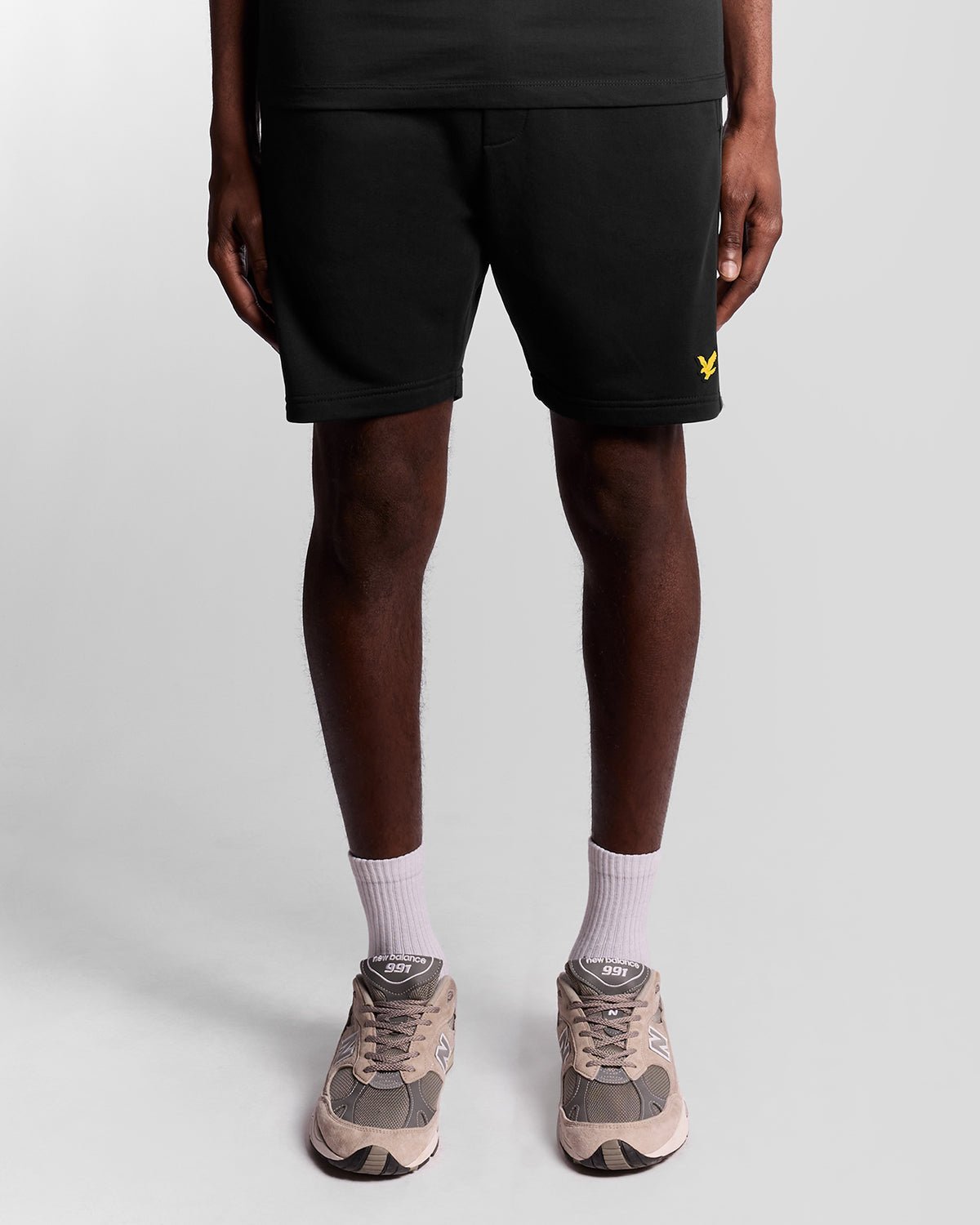 Homme portant un short de sport en bande adhésive, couleur noir de jais