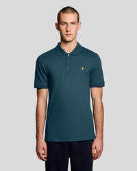 Man wears Everyday Cotton Polo Shirt in Rich Teal