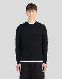 Man wears Lambswool Crew Neck Jumper in Jet Black
