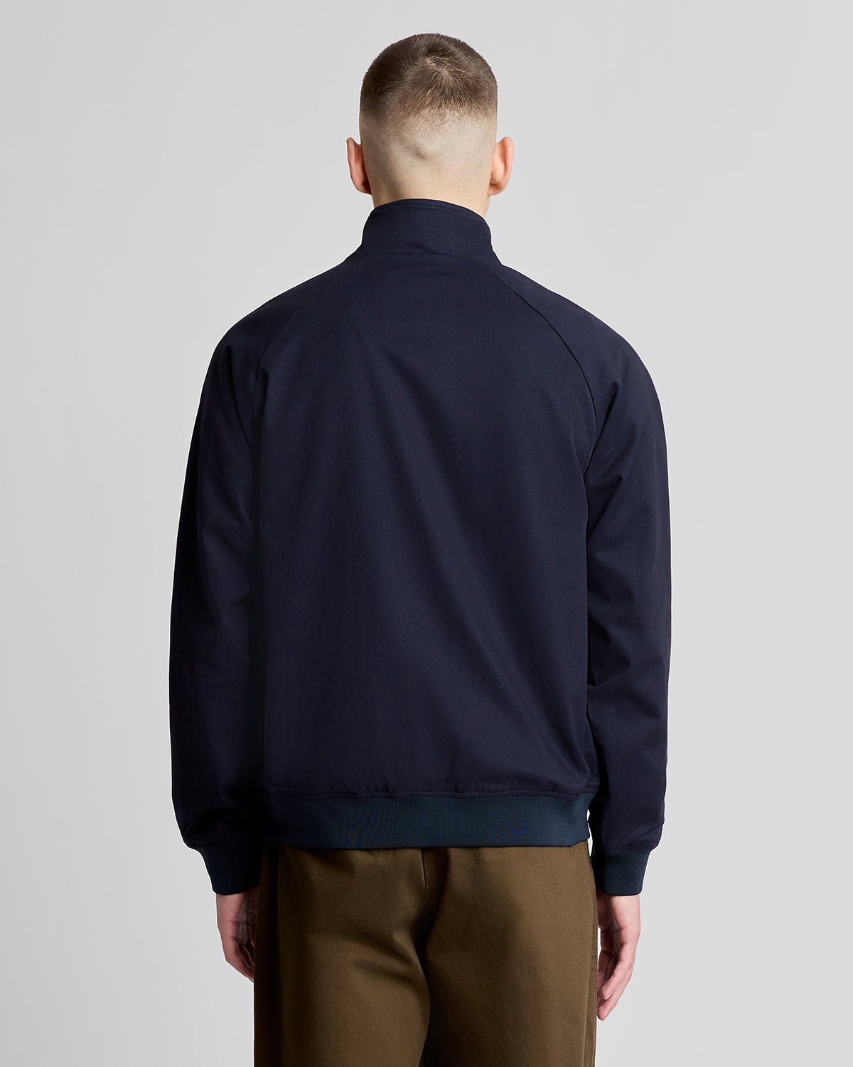 Man wears Cotton Harrington Jacket in Dark Navy