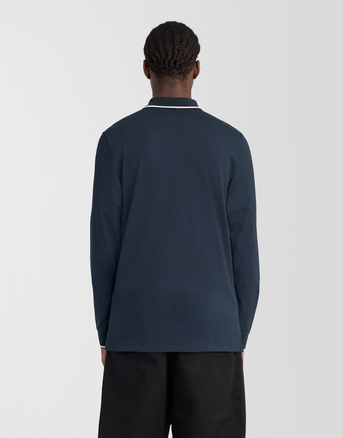 Man wears Tipped Long Sleeve Polo Shirt in Dark Navy/ White