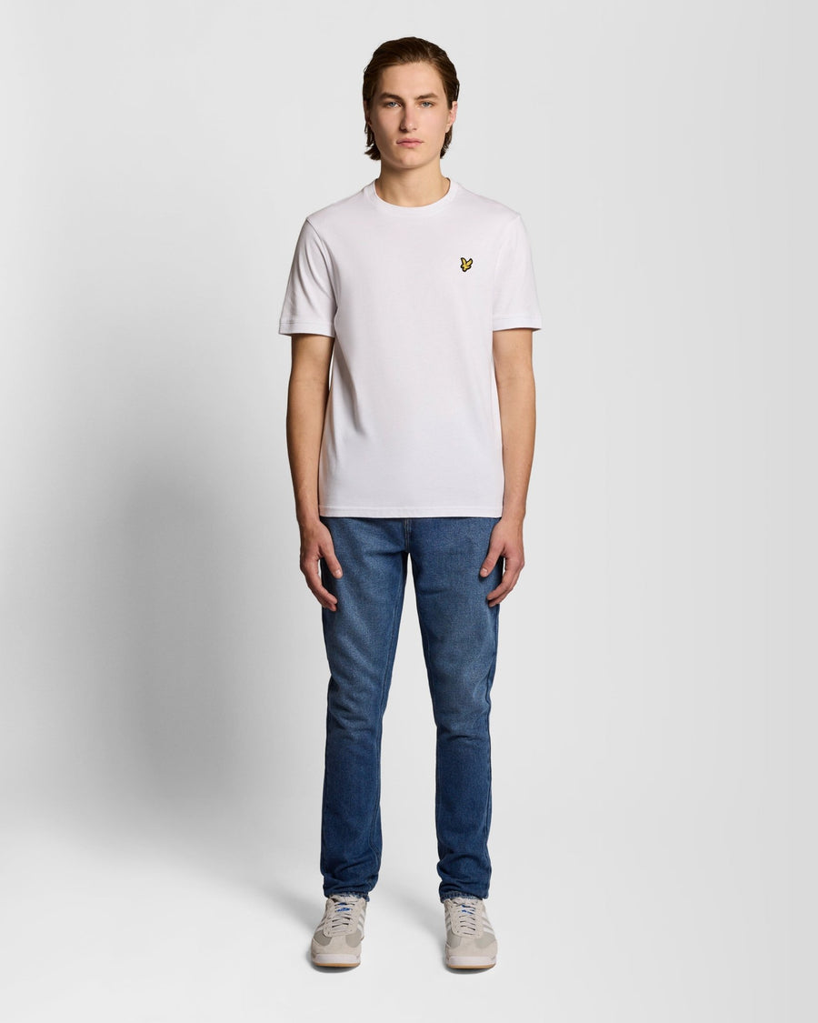Uomo con jeans slim a zampa in indaco