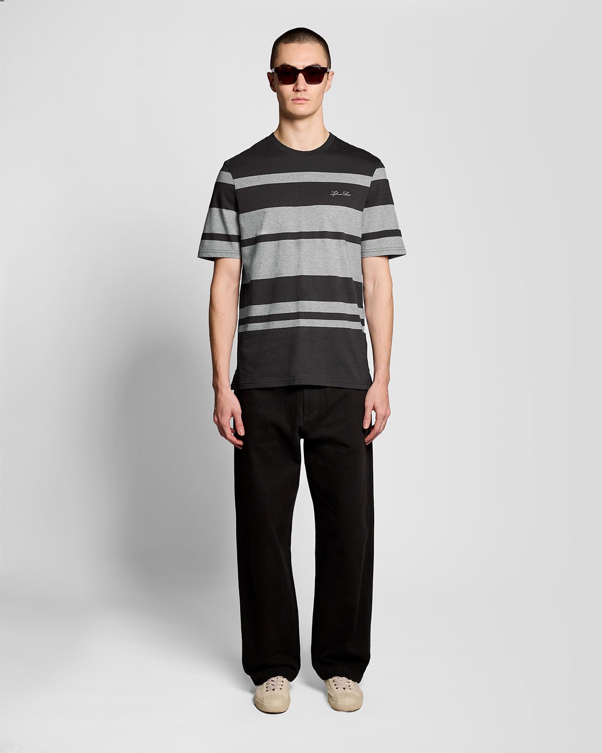 Man wears Relaxed Fit Stripe T-Shirt in Charcoal Grey/ Light Grey Marl