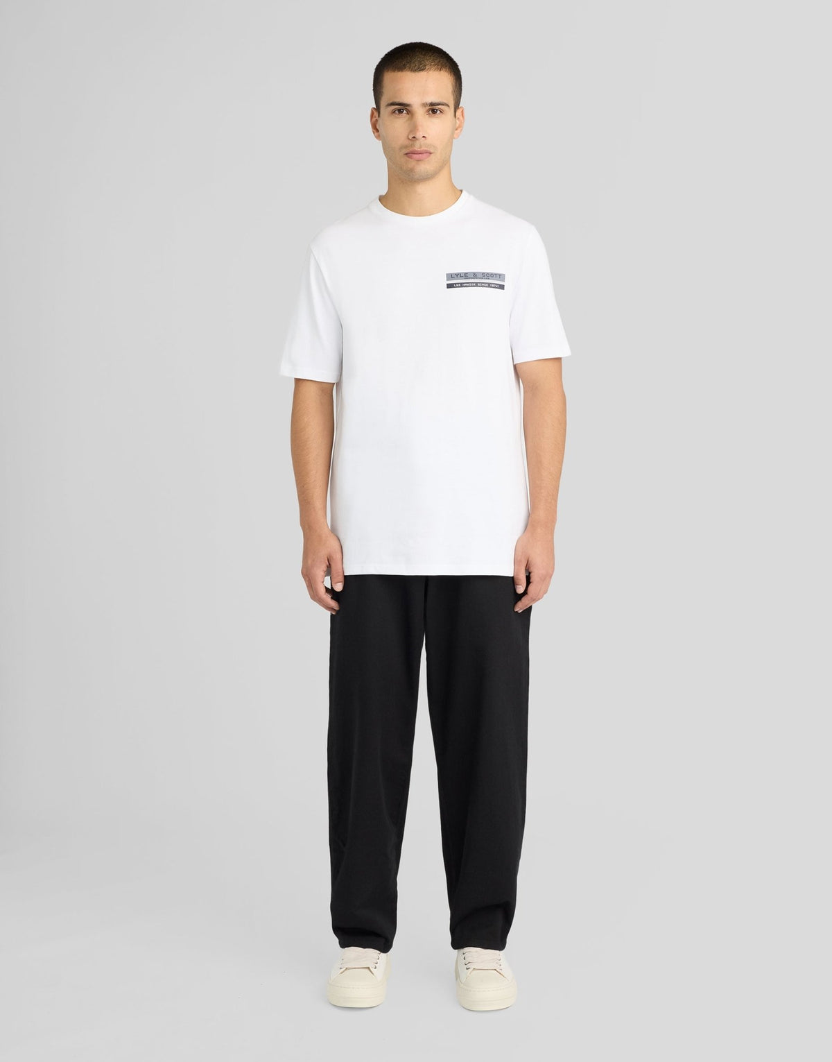 Man wears TV Pixel Back Graphic T-Shirt in White