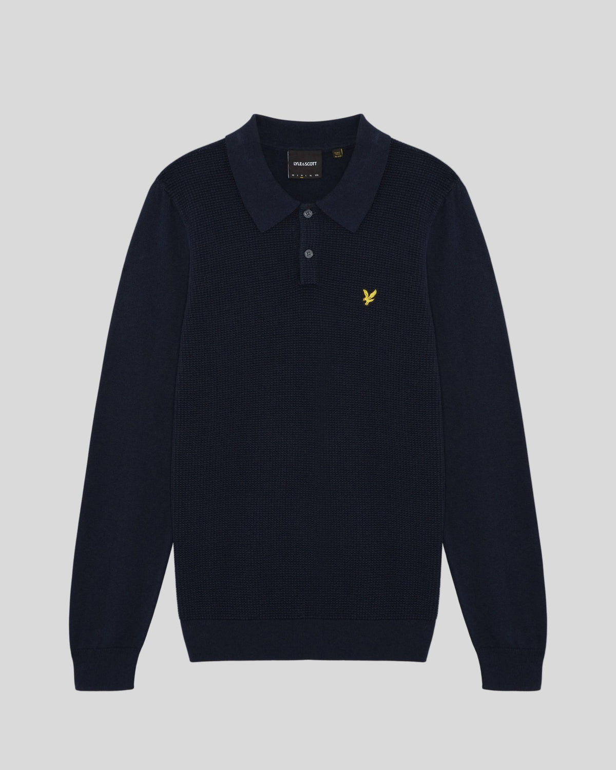 Man wears Waffle Knitted Long Sleeve Polo Shirt in Dark Navy