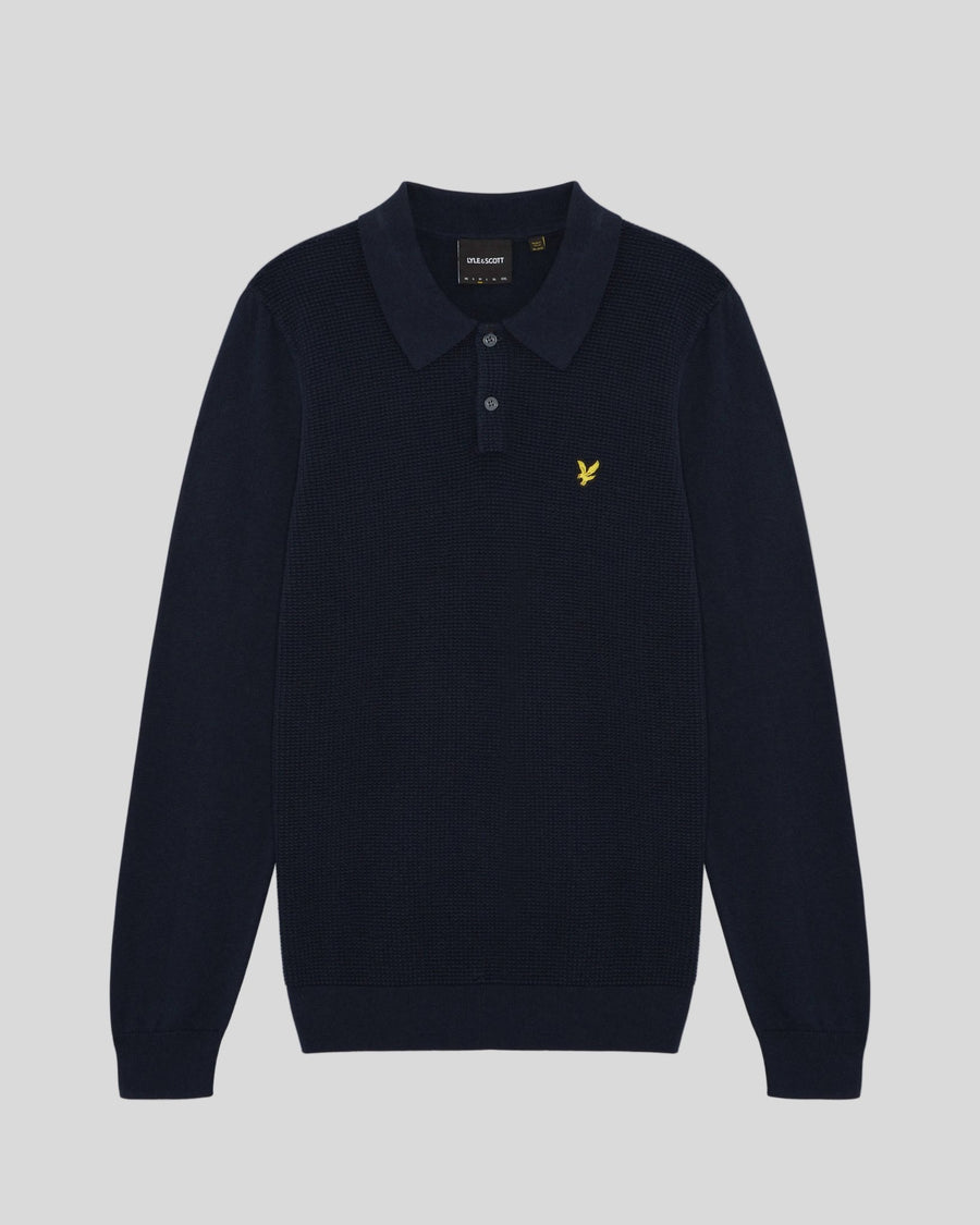 Man wears Waffle Knitted Long Sleeve Polo Shirt in Dark Navy