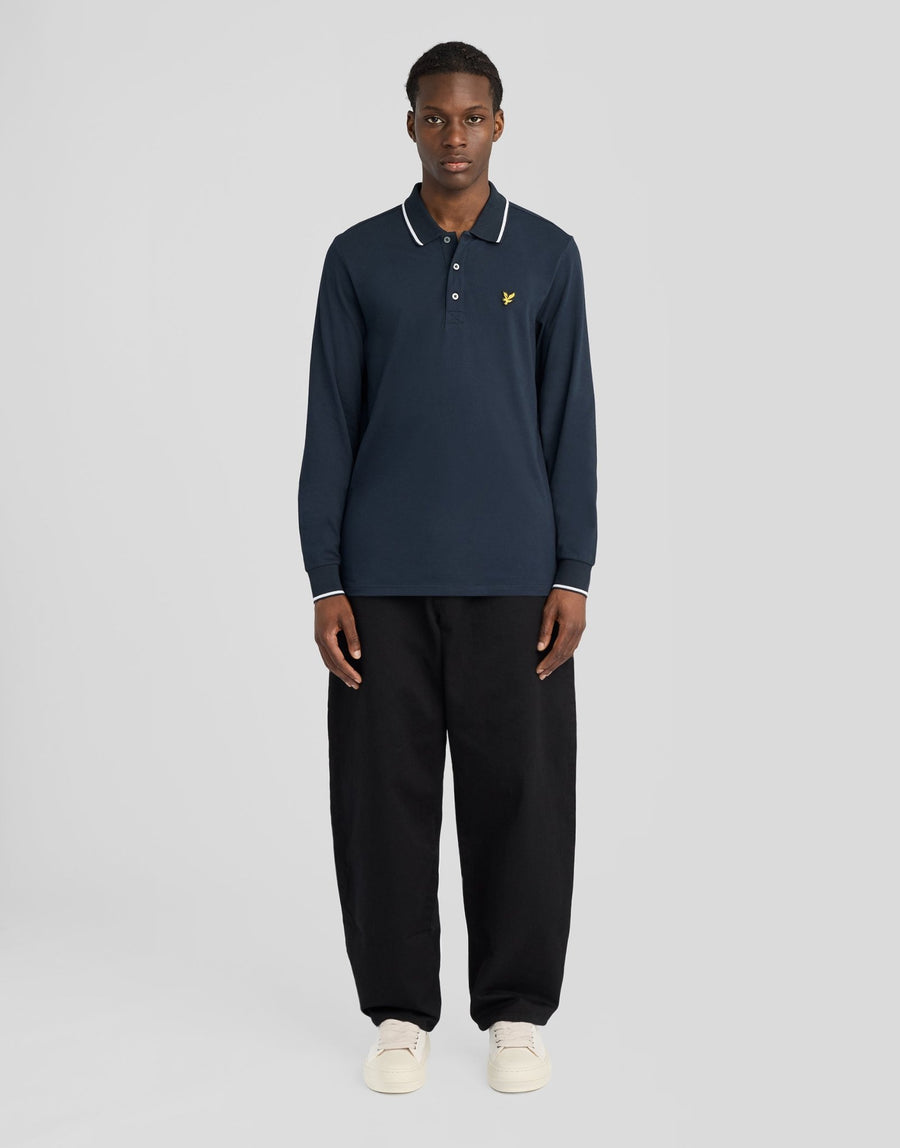 Man wears Tipped Long Sleeve Polo Shirt in Dark Navy/ White